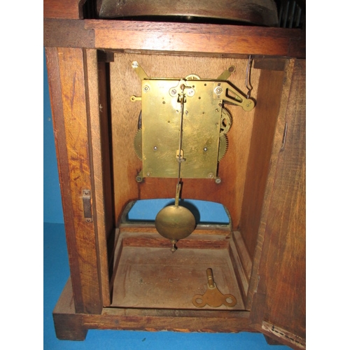 285 - An early 20th century Arts & Craft mantle clock, striking on a  bell with oak and brass body, with k... 