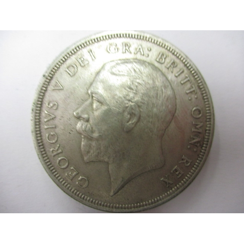 135 - A George V crown dated 1930 and a half crown dated 1916, circulated coins with very fine definition ... 