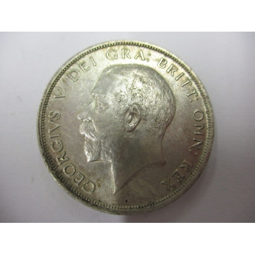 135 - A George V crown dated 1930 and a half crown dated 1916, circulated coins with very fine definition ... 