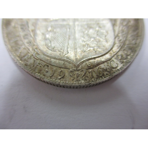 135 - A George V crown dated 1930 and a half crown dated 1916, circulated coins with very fine definition ... 