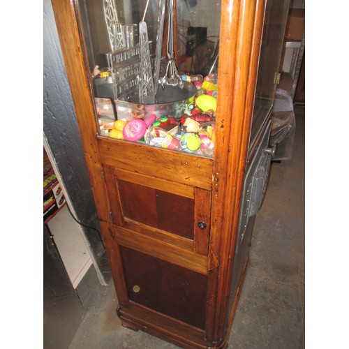 298 - A vintage coin operated grab crane arcade machine, being a continental model, in current working ord... 