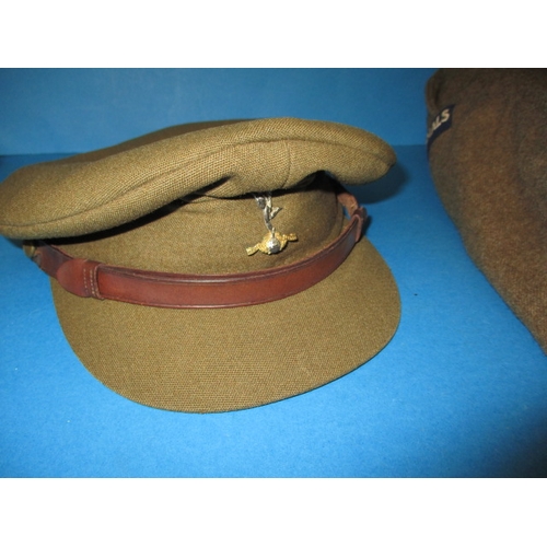 232 - A 1950 Royal Signals Captains battledress blouse and a REME officers peak cap, in used condition