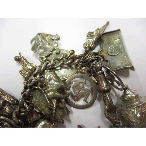 143 - A vintage sterling silver charm bracelet, to include a Victorian coin charm, approx. weight 85.9g, i... 