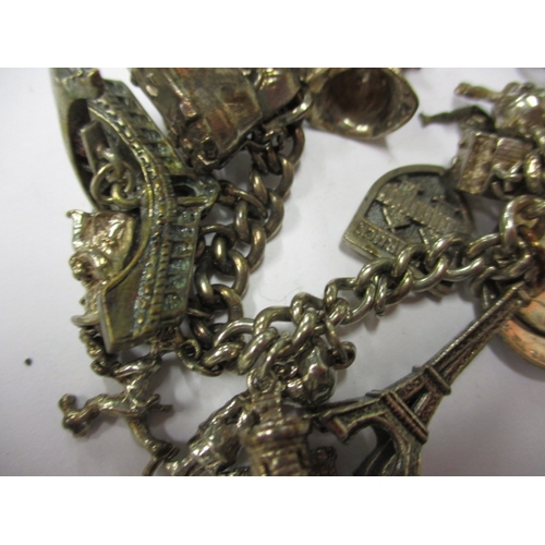 143 - A vintage sterling silver charm bracelet, to include a Victorian coin charm, approx. weight 85.9g, i... 