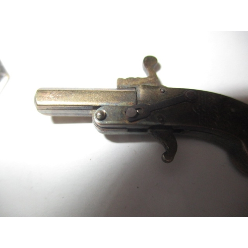 145 - A vintage white metal pistol charm with working mechanism and a decorative plated trowel, in useable... 