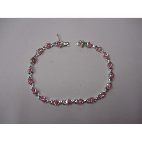 147 - A silver and pink stone hearts and kisses bracelet, approx. linear length 18cm, in useable pre-owned... 