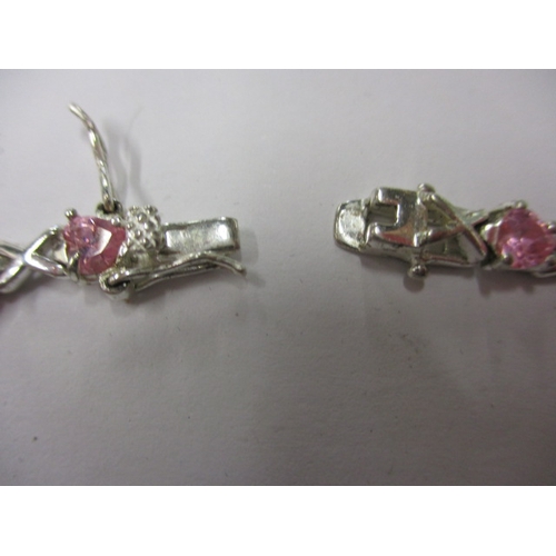 147 - A silver and pink stone hearts and kisses bracelet, approx. linear length 18cm, in useable pre-owned... 