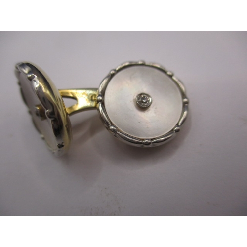 74 - A pair of 585ct gold cufflinks with mother of pearl panel and a small central diamond to each face, ... 