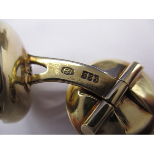 74 - A pair of 585ct gold cufflinks with mother of pearl panel and a small central diamond to each face, ... 