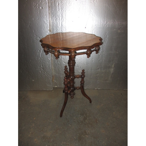 293 - A 19th Century walnut wine table, with profuse turned under tier. Minor age related marks, useable p... 