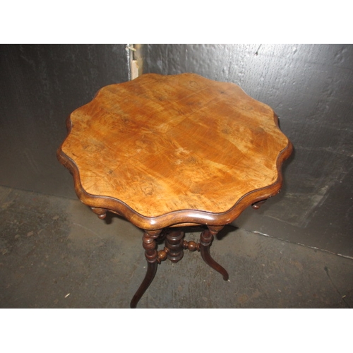 293 - A 19th Century walnut wine table, with profuse turned under tier. Minor age related marks, useable p... 