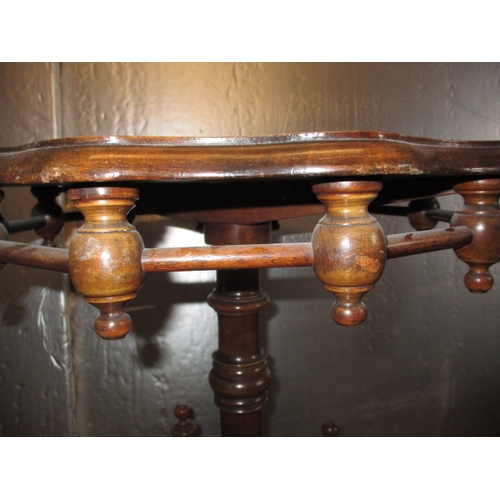 293 - A 19th Century walnut wine table, with profuse turned under tier. Minor age related marks, useable p... 