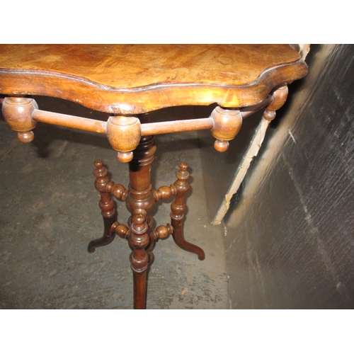 293 - A 19th Century walnut wine table, with profuse turned under tier. Minor age related marks, useable p... 