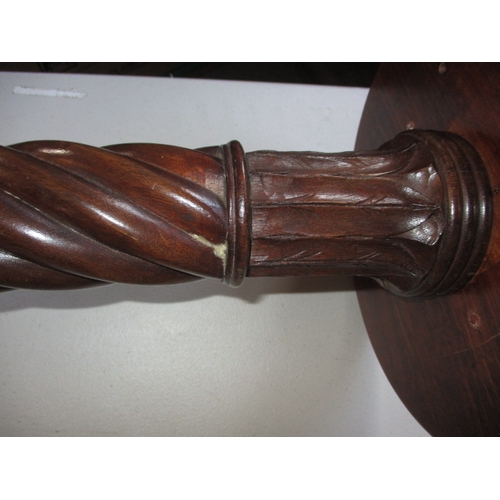 292 - A vintage mahogany torchiere with spiral turned column and associated top. In good useable condition... 