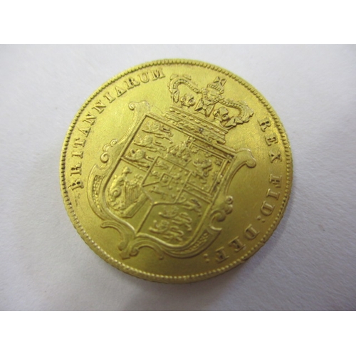 123 - A George IV full gold sovereign dated 1825, a circulated coin with very good definition of features,... 