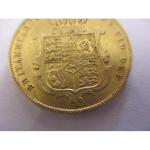 123 - A George IV full gold sovereign dated 1825, a circulated coin with very good definition of features,... 