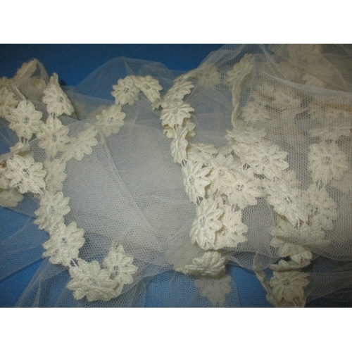 62 - A vintage lace veil and train, with integral head cap, in used condition