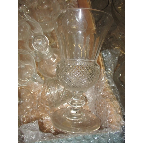 82 - A large quantity of antique and later glasswares, to include decanters and hand-blown drinking glass... 