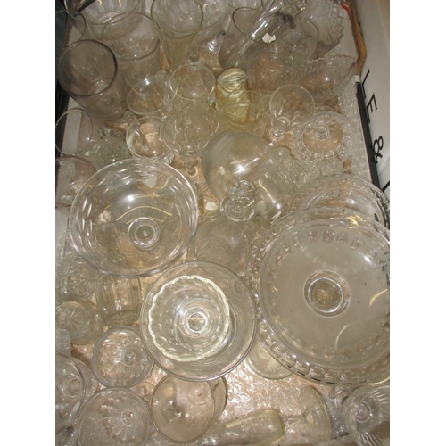 82 - A large quantity of antique and later glasswares, to include decanters and hand-blown drinking glass... 