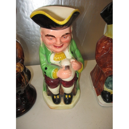 176 - 3 vintage toby jugs, to include a musical example. One jug with crack. Approximate height of largest... 