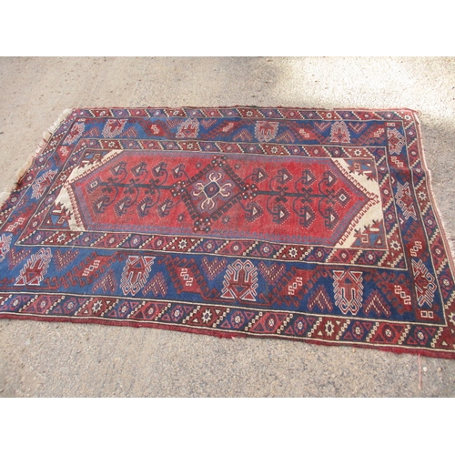 193 - A vintage Persian hand knotted wool rug. Approximate size 190cm x 130cm, in used condition with mino... 