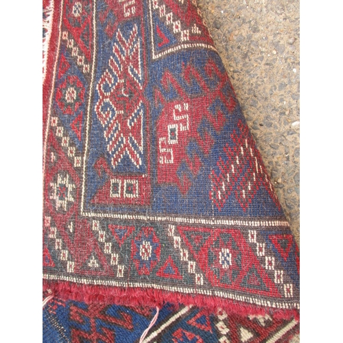 193 - A vintage Persian hand knotted wool rug. Approximate size 190cm x 130cm, in used condition with mino... 