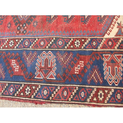 193 - A vintage Persian hand knotted wool rug. Approximate size 190cm x 130cm, in used condition with mino... 