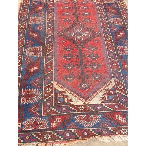 193 - A vintage Persian hand knotted wool rug. Approximate size 190cm x 130cm, in used condition with mino... 