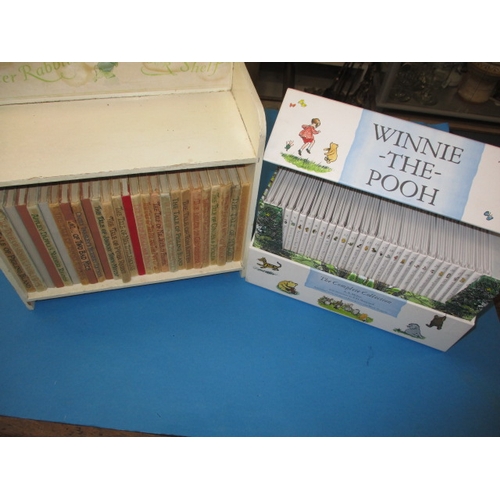 201 - A miniature wood bookcase with contents of Beatrix Potter books in well used condition and a boxed s... 