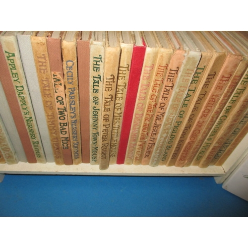 201 - A miniature wood bookcase with contents of Beatrix Potter books in well used condition and a boxed s... 