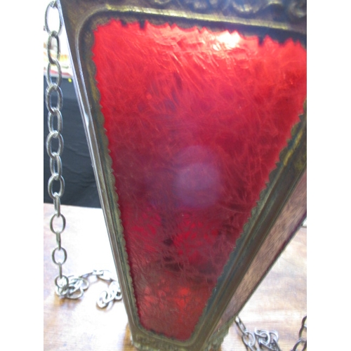 206 - An early 20th century hanging lantern shade with git metal body and decorative red glass panels, app... 