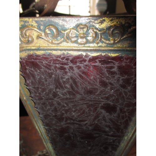 206 - An early 20th century hanging lantern shade with git metal body and decorative red glass panels, app... 