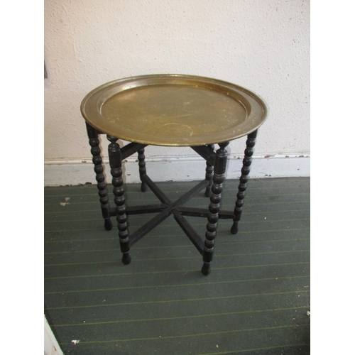 A vintage Asian brass topped folding table, in useable pre-owned condition