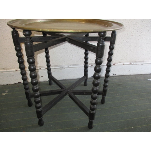 213 - A vintage Asian brass topped folding table, in useable pre-owned condition