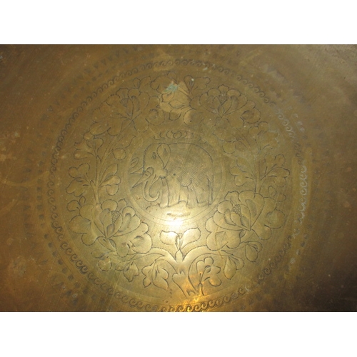 213 - A vintage Asian brass topped folding table, in useable pre-owned condition