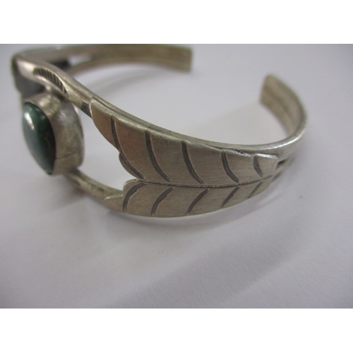 141 - A near antique American Navajo tribe coin silver wrist cuff with central hard stone, being hand made... 