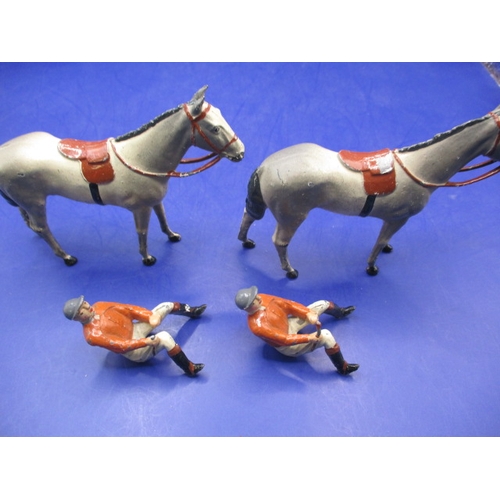 181 - Two vintage Britain’s lead horse and jockey figures, both look to be missing crop ends, legs and arm... 