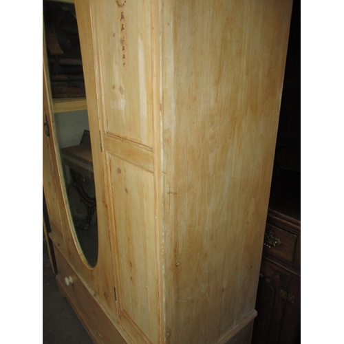 266 - A waxed natural wood wardrobe, having drawer base and mirrored door. Comes in 3 parts for ease of tr... 