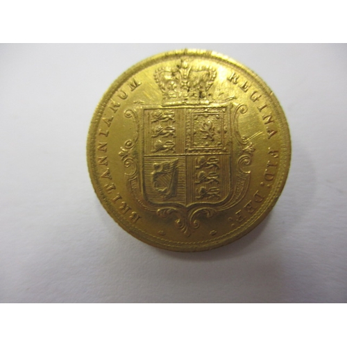 121 - A Victorian gold half sovereign dated 1884, with shield back, a well circulated coin with fine defin... 