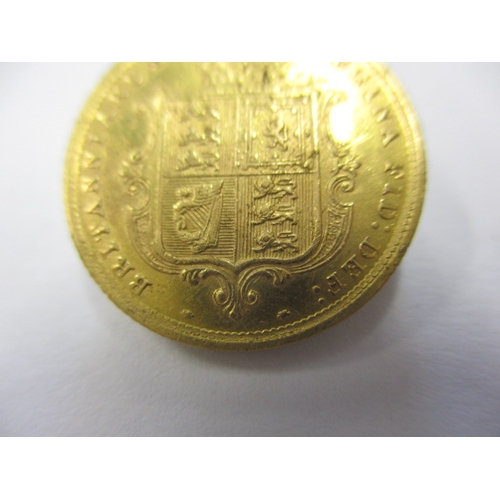 121 - A Victorian gold half sovereign dated 1884, with shield back, a well circulated coin with fine defin... 