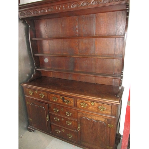 273 - An antique oak kitchen dresser, with removable top rack 3 frieze drawers, central dummy drawers and ... 