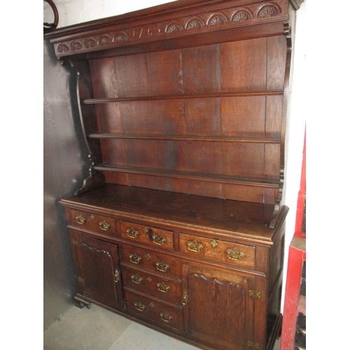 273 - An antique oak kitchen dresser, with removable top rack 3 frieze drawers, central dummy drawers and ... 