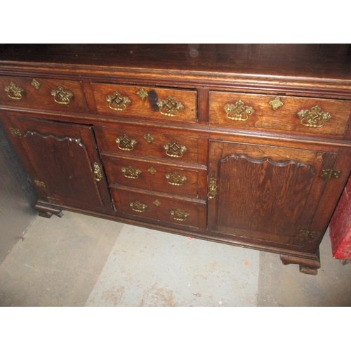 273 - An antique oak kitchen dresser, with removable top rack 3 frieze drawers, central dummy drawers and ... 