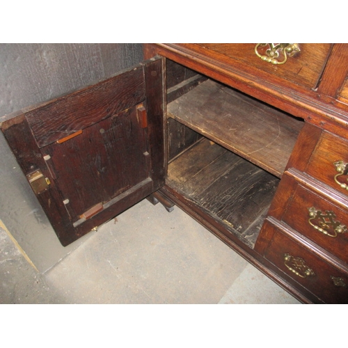 273 - An antique oak kitchen dresser, with removable top rack 3 frieze drawers, central dummy drawers and ... 