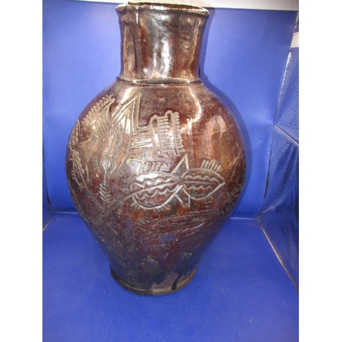 184 - An antique treacle glazed water jug having incised organic form decoration with date of 1658, approx... 