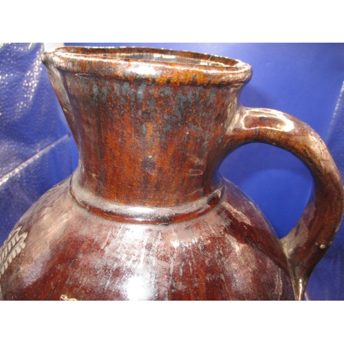 184 - An antique treacle glazed water jug having incised organic form decoration with date of 1658, approx... 