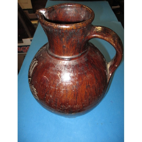 184 - An antique treacle glazed water jug having incised organic form decoration with date of 1658, approx... 