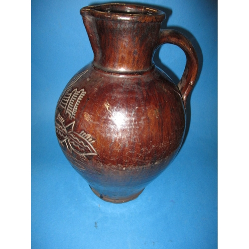 184 - An antique treacle glazed water jug having incised organic form decoration with date of 1658, approx... 