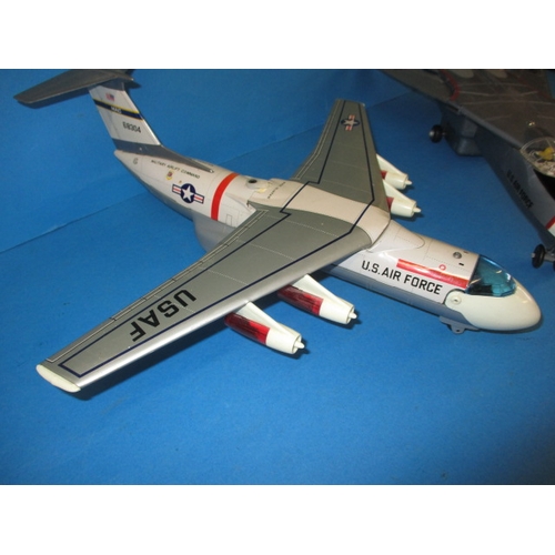 250 - Two vintage battery operated tin and plastic model aircraft, both believed to be in working order wi... 