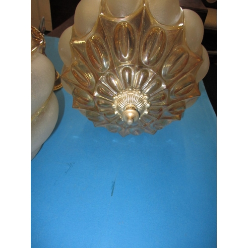 280 - A pair of decorative ceiling lamps, each having frosted and lustre glass shades with gilt metal moun... 